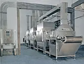 A large industrial kitchen with many machines and equipment.