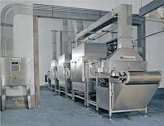 A large industrial kitchen with many machines and equipment.